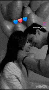a black and white photo of a man kissing a woman 's forehead with balloons in the background