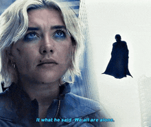 a woman says " it what he said we all are alone " next to a man in a cape