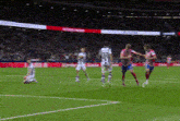 a group of soccer players are playing a game on a field