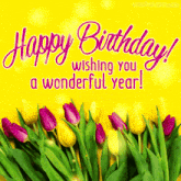 a birthday card with purple and yellow flowers and the words happy birthday wishing you a wonderful year