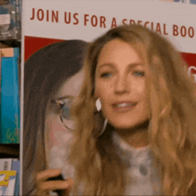 a woman is smiling in front of a sign that says join us for a special book