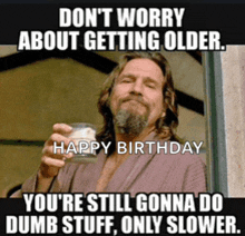 a man in a robe is holding a glass of whiskey and says " don 't worry about getting older "