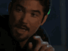a close up of a man with a mustache holding a fork