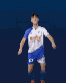 a man in a blue and white jersey with the number 10 on his shorts
