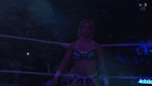a woman is standing in a wrestling ring with a sign that says mobile a on it