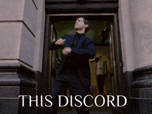 a man in a suit is dancing in a doorway with the words this discord behind him