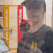 a blurry picture of a man in front of a sign that says kitchen
