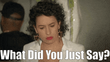 a woman with curly hair and earrings is asking what did you just say