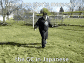 a man is walking through a grassy field with a sword in his hands .
