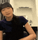 a woman wearing headphones is sitting in front of a mirror .