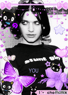 a man wearing a black shirt that says stunt girl you is surrounded by purple butterflies