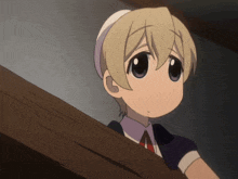 a little girl with blonde hair and blue eyes is sitting on a staircase
