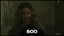 a woman is touching another woman 's face and the woman is saying `` boo '' .