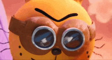 a close up of a cartoon character wearing goggles and an angry face