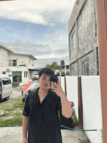 a man taking a picture of himself in front of a building