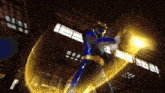 a blue and gold superhero is holding a glowing object in his hand