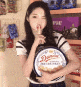 a girl holds a tin of danisa butter cookies
