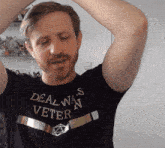 a man is wearing a shirt that says deal wars veteran