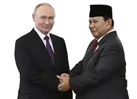 a man in a suit and tie shakes hands with another man