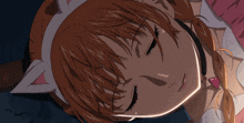 a girl wearing a cat ear headband is sleeping