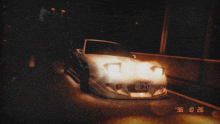a car with a license plate that says 38-47 is driving down a road at night