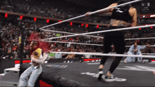a woman in a wrestling ring with the word win on the screen