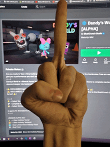 a person holds up their middle finger in front of a computer screen that says dandy 's alpha on it