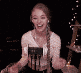 a woman wearing ear buds and headphones with a clock that says 3:38 on it