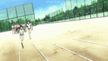 a group of girls running on a track wearing white shirts