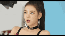 a close up of a woman wearing a choker