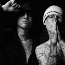 a black and white photo of a man wearing a beanie that says ' pybhmhoc ' on it