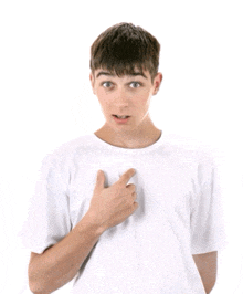 a young man in a white t-shirt points to his chest
