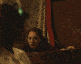 a woman with a green headband on her head looks down