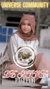 a woman in a hijab sits in front of a poster that says universe community de moke eagle 09
