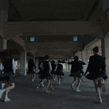 a girl in a school uniform is dancing with her hands in the air