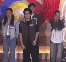 a group of people are standing on a stage with a man wearing a name tag that says will