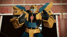 a transformer with horns and blue eyes is standing in front of a red wall