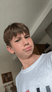 a young boy wearing a white t-shirt that says ' i love you ' on it