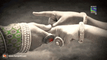 a black and white photo of a man and woman holding hands with sony television hd written on the bottom