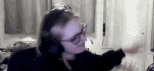 a person wearing headphones and glasses is dancing
