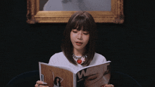 a woman reads a magazine with the word want on the cover