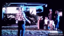 a group of people are standing in front of a house and a sign that says hd bravo