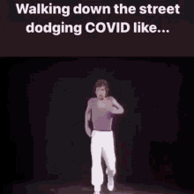 covid19 covid mick jagger walking down the street dodging covid