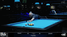 a man is playing pool on a table that says diamond