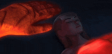 a red hand is glowing in the dark with a dark background