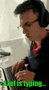 a man wearing headphones and glasses is typing on a laptop .