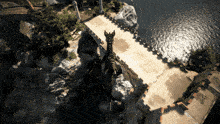 an aerial view of a bridge over a body of water with a castle in the background