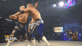 two wrestlers are fighting in a ring with the nwa logo on the bottom