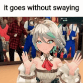 a girl with a crown on her head is waving her hands in front of a group of people .