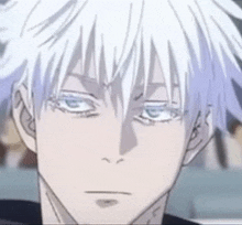 a close up of a man 's face with white hair and blue eyes looking at the camera .